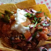 Coconut & bean chilli nachos served with jalapenos, sour cream, chilli jam & salsa at The 78 in Glasgow