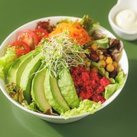 Avocado salad bowl — generously topped with Japanese organic avocado, sprouts, chickpeas, tomatoes & beet quinoa. Served with house-made dressing. Fully vegan & gluten-free. at L for You in Tokyo