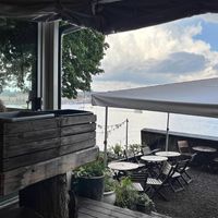 Outdoor seating with harbor views  at Hermans in Stockholm