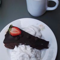 Chocolate cake and whipped cream (all vegan). Tea is free at Hermans. at Hermans in Stockholm