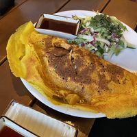 A crispy pancake filled with mushrooms and vegetables and tofu plus a salad  at Good Morning Vietnam Vegan in Berlin