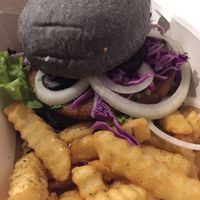 My custom vegan burger creation with amazing fresh crinkle cut fries. I went with the chickpea patty, charcoal bun, herb spread, greens, cabbage, tahini sauce... So delish!  at Black House Burgers in Kuta