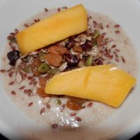 Porridge made with coconut milk and topped with dried fruit, seeds and mango at Caffe Nero in Spalding