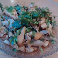 Sliced hedgehog mushrooms, marinated in chili and Sichuan pepper oil, coriander, and roasted garlic, served with peanuts and spring onions. at Lao Wai in Stockholm