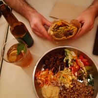 falafel pita to the top and seitan shawarma bowl to the bottom with homemade iced tea and local ipa at Falafeleria - Sta Barbara in Madrid