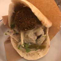 Falafel in pitta with hummus and tahini sauce - doesn’t look big but it was a decent portion with at least 4-5 big sized falafel balls and lots of salad and sauce in between  at Falafeleria - Sta Barbara in Madrid