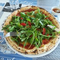 Pizza with vegan chesse, zucchini, peppers and plenty of arugula at Pizzeria Fuoriseria in Izola