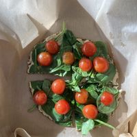 Raw pizza - hummus, spinach, tomato, olive oil at Vibe Organic Juice Bar in St Louis Park