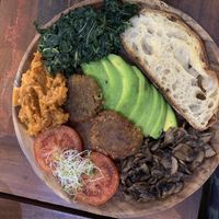 Full breakfast with tomato, home made baked beans (YUM), sautéd mushroom, avocado, spinach & sourdough toast! at Namaskara Coffee & Superfoods in Ubud