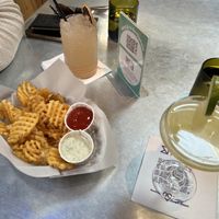 Waffle fries w/ vegan ranch and ketchup. Drinks are a guava fizz w/ vodka and a mouth of Sundays    at Bang Up To The Elephant in Denver
