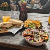 Tofu sandwich, tempeh salad, guacamole and chips. at Raiz in Sintra