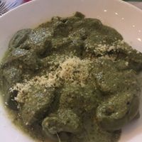 Spinach pasta stuffed with vegan cheese and mushrooms with pesto sauce  at Lazy Vegan in Santiago