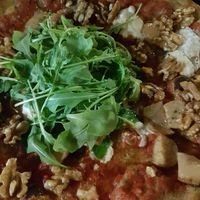 Personal pizza: almond Mozzarella with porcini mushrooms, walnuts, arrugula and help dough. 9 euros at Lore Pizzeria in Lecce