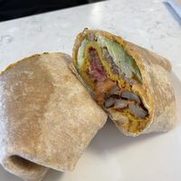 The common roots breakfast burrito, with added cheese saucee  at Common Roots Cafe in Rye