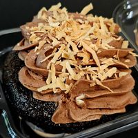 Vegan chocolate cupcake with chocolate frosting and toasted coconut shreds. So good! at Cupcake Magic in Yuba City