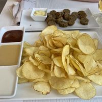 Papas con 2 salsas veganas y ración de butifarra vegana  at La Casa de la Montaña in Jaca
