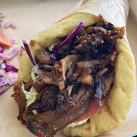 Space Gyro close up.  It has tomato , tahini, oyster mushroom , cabbage, lettuce I think   at Vegan Beat in Athens