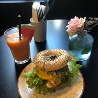 Smoothie served with watermelon and a sesame bagel with vegan chickn, cheeze, avocado and pesto mayo (September 2023)  at Olivia's Maastricht in Maastricht