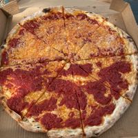 Half regular half garlic parm pizza at Mora Pizza in Miami