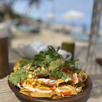 Vegan nacho bowl with vegan cheese and vegan sour cream, beans and guacamole 🥑   at Genius Cafe in Sanur