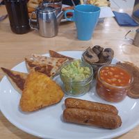 Potato cakes, hashbrown, bacon, sausages, mashed avocado, beans and mushrooms at Causeway Cafe in Belfast