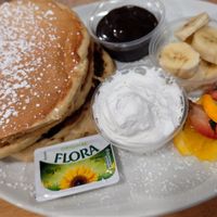 Fluffy American style pancakes with choc sauce and whipped cream and banana at Causeway Cafe in Belfast