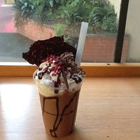 Chocolate milkshake with dark chocolate sauce and bark, with dried berries and coconut whip cream. at Wellington Chocolate Factory in Wellington