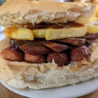 Vegan bacon and sausage sandwich with chips at The Avenues Cafe in Nottingham
