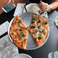 Vegan cheese with half tomatoes and half olives at Veggie Crust in Brookline