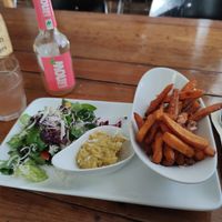 Sweet potatoes fries, hummus, salad, and soft drink at Genusswerkstatt in Potsdam