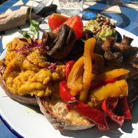 Vegan “eggs”, avocado, mushrooms, grilled peppers, tomatoes, salad and bread at Cafe Barcelona in South West London