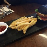 vegan burger in black bun  at Water Drop Vegetarian Cafe in Christchurch