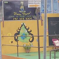 outside (yellow building, green sign) beautiful artwork too😄 at Pachamama Health Food in Humacao