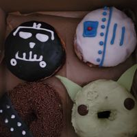 "May the Fourth" box: R2D2
Lemon glaze filled with house-made strawberry jam.
Chewbacca
Chocolate glaze, chocolate sprinkle!
Baby Yoda
Matcha glaze with tasty white chocolate ears. at Strange Matter Coffee - Eastside in Lansing