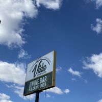 Outside signage with fluffy clouds at Vida Vegan  at Vida Eatery  in Bakersfield