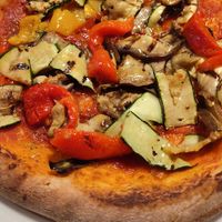 Pizza with a side of vegetables added. at Olivo in Verona