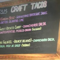 Menu board showing vegan tacos at Screaming Goat in Sarasota