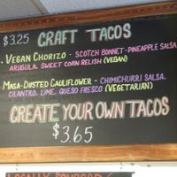 Menu board showing vegan tacos at Screaming Goat in Sarasota