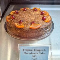 Tropical ginger and macadamia cake (vegan). Available by the slice or as a whole cake. April 2026 at Johnny Baker in Castlemaine
