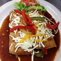 Enchiladas with traditional rojo sauce and Violife cheese.   at El Tipico in Toledo