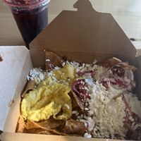 Chilaquiles with egg and Jamaica agua fresca   at Delicias Bakery in Los Angeles