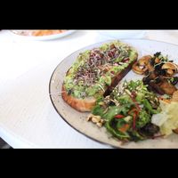 Avocado toast with optional extras of roasted mushrooms and tofu at Honey Cafe and Bakery in Kyiv