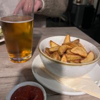 Beer & potato wedges, ketchup had a pepper/ chilli kick  at Manna 68 in Gdansk