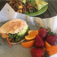 Vegan burger with side of fruit, and fajitas behind. at The TURN Around - Peachtree in Cookeville