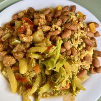 Brown rice with beans on top, soy chunks in tomato stew, mixed veggiess  at Tony's F in Santo Domingo