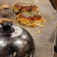 Vegan okonomiyaki cooking on a freshly cleaned cook top at Kamehameha - かめはめは in Kyoto