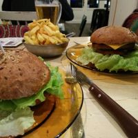 Homemade burger bun, veggie burger, vegan cheese, caramelized onions, salad and tomato. Large portion of fries at Melemele Burguer in Zarautz