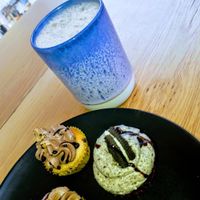 Vegan chai latte and three vegan cupcakes... two with cookie dough flavour, and one with Oreo flavour. at Bake My Day in Copenhagen