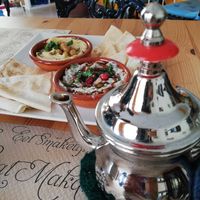 Tapa de hummus y mtabal. Infusión de jengibre con limón at La Siria in Malaga