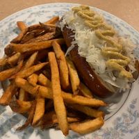 Beyond brat on pretzel bun with sauerkraut and French fries   at Thrive Diner in Pittsfield